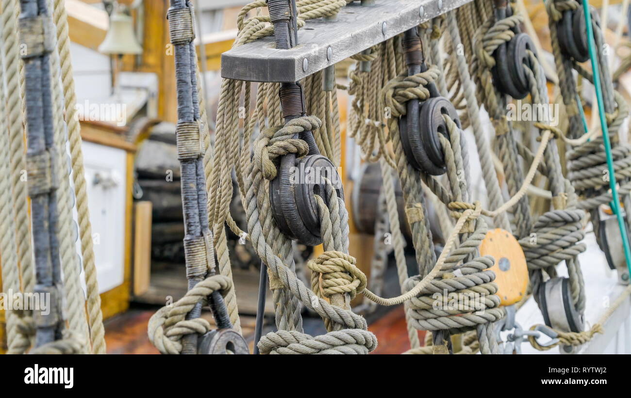 Ropes and knots of the big ship docking on the port it is the part of the velum of the ship Stock Photo