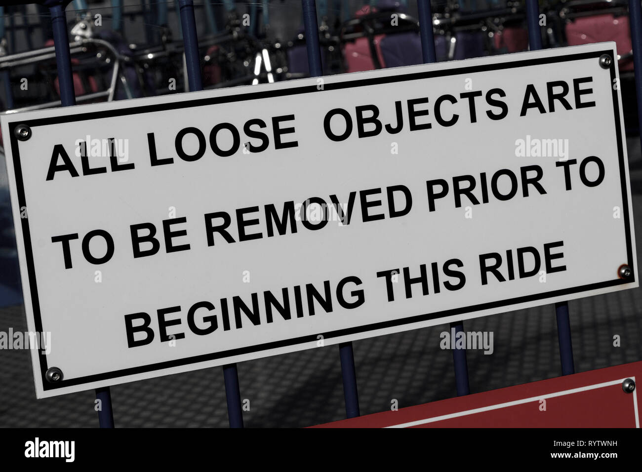 Sign in a funfair warning 'All loose objects are to be removed prior to beginning this ride'. Health and safety. Stock Photo