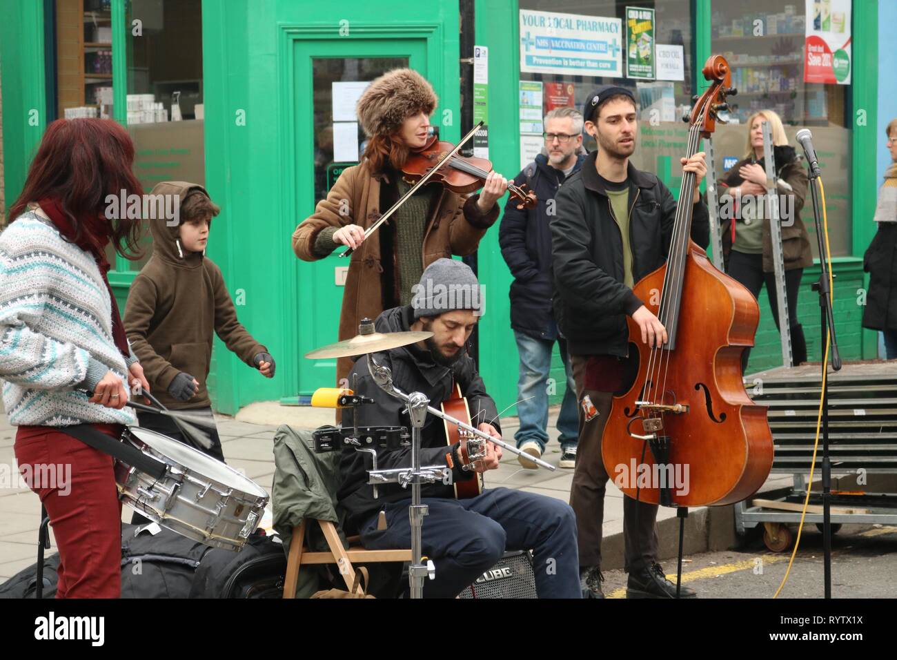 Group of buskers in London street with double bass, violin and drums Stock Photo