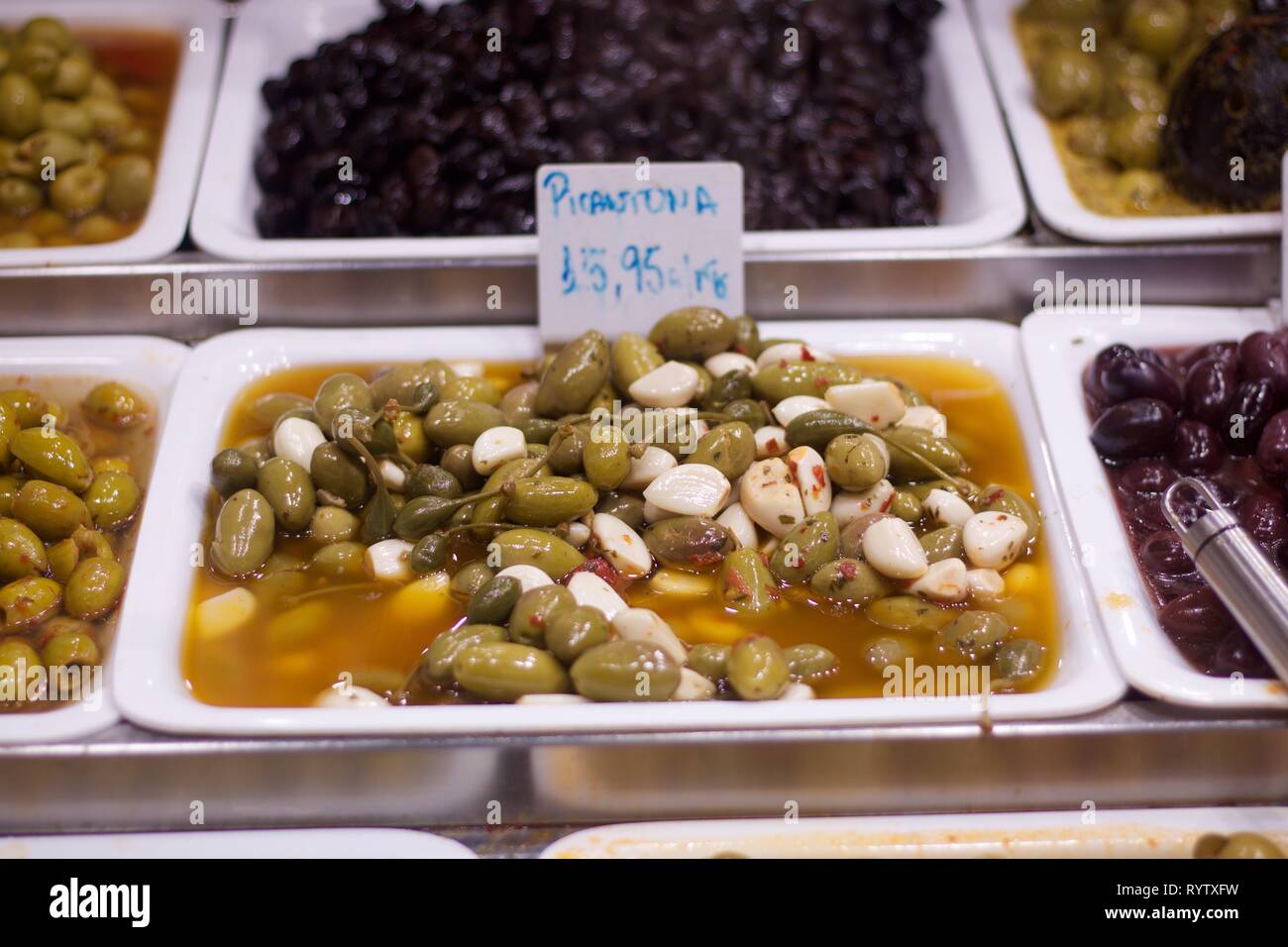 Green Olives and Garlic Cloves In Olive Oil Offered for Sale Stock
