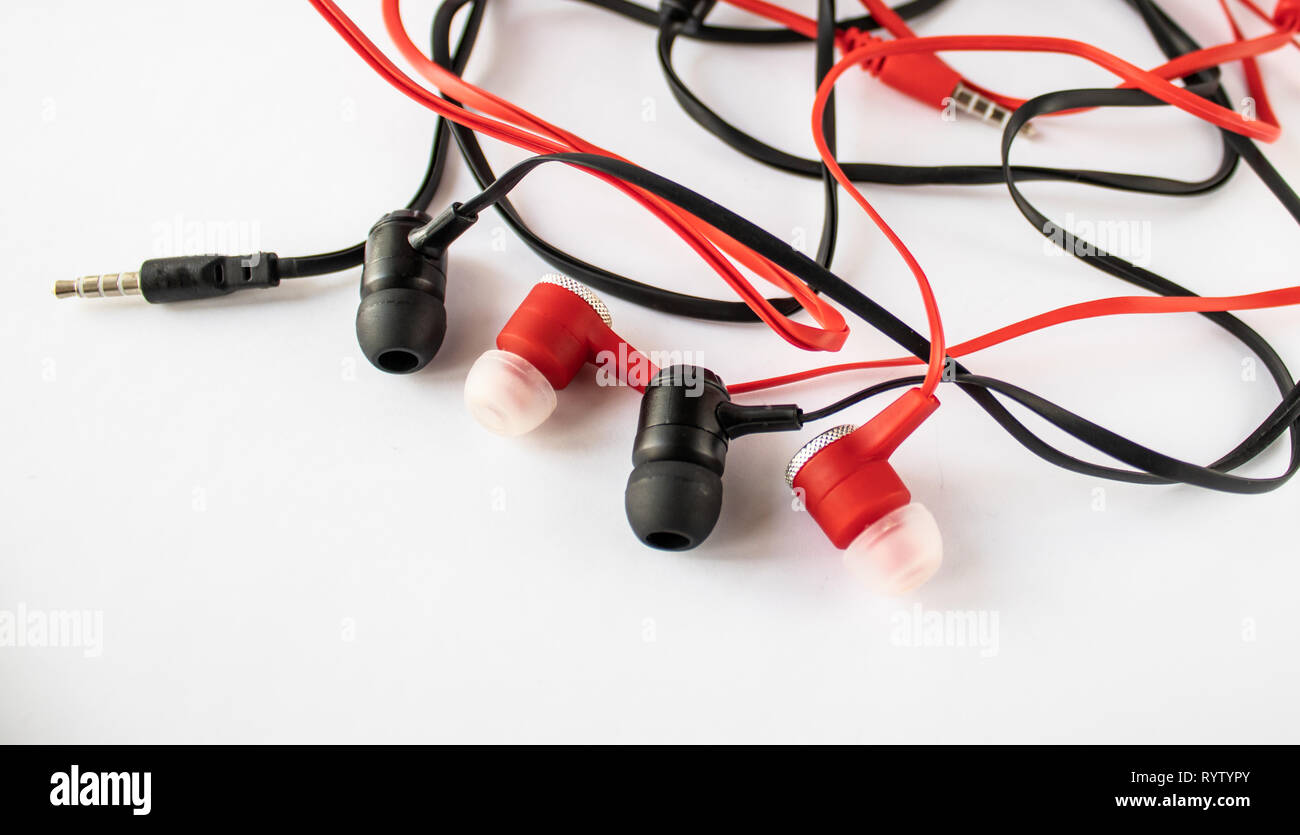 Black and red small headphones on a white background Stock Photo - Alamy