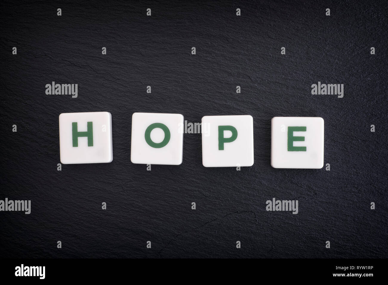 Word Hope on a black slate background. Close up. Stock Photo