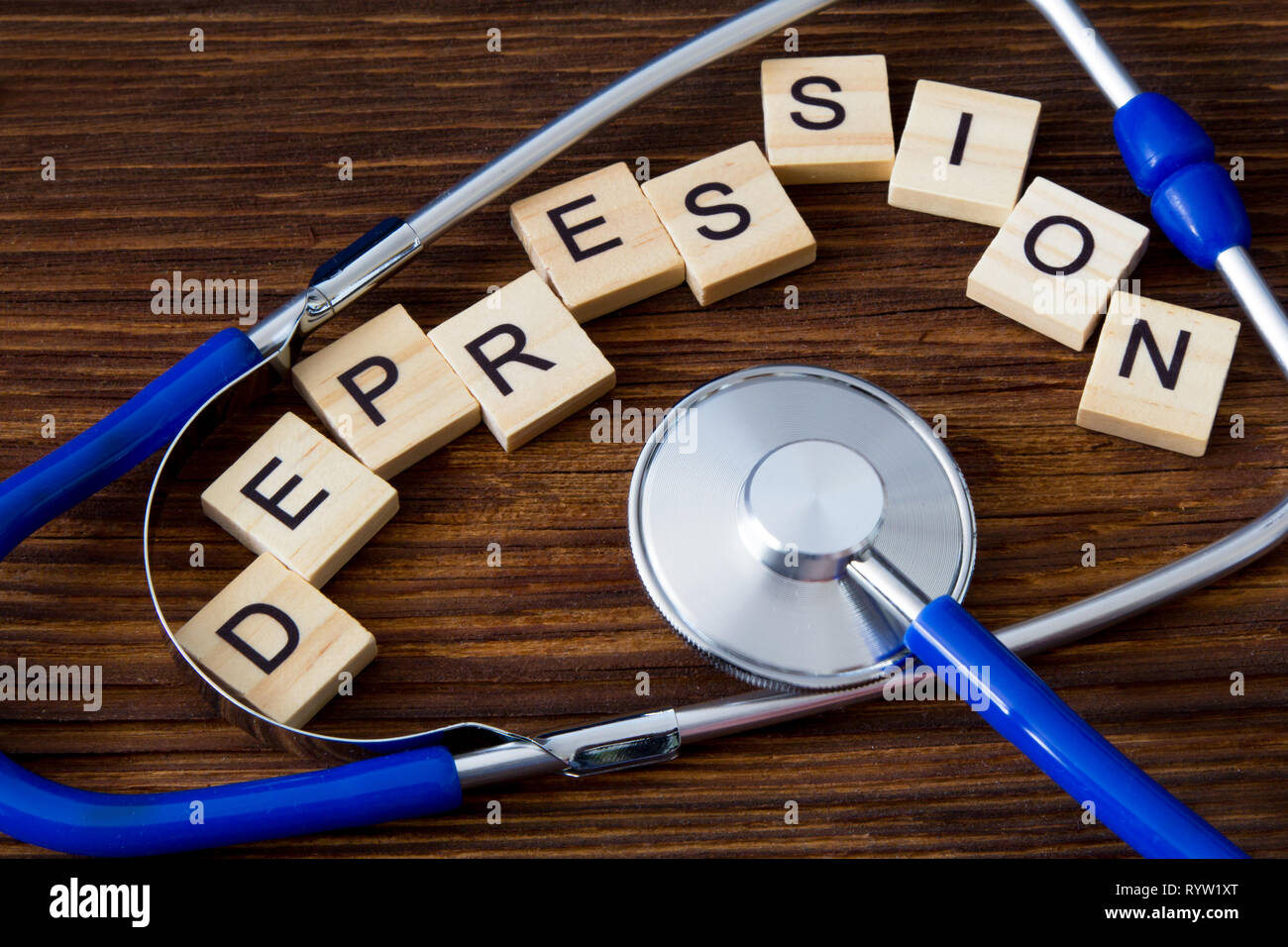 'Depression' word written on wooden blocks between stethoscope Stock Photo