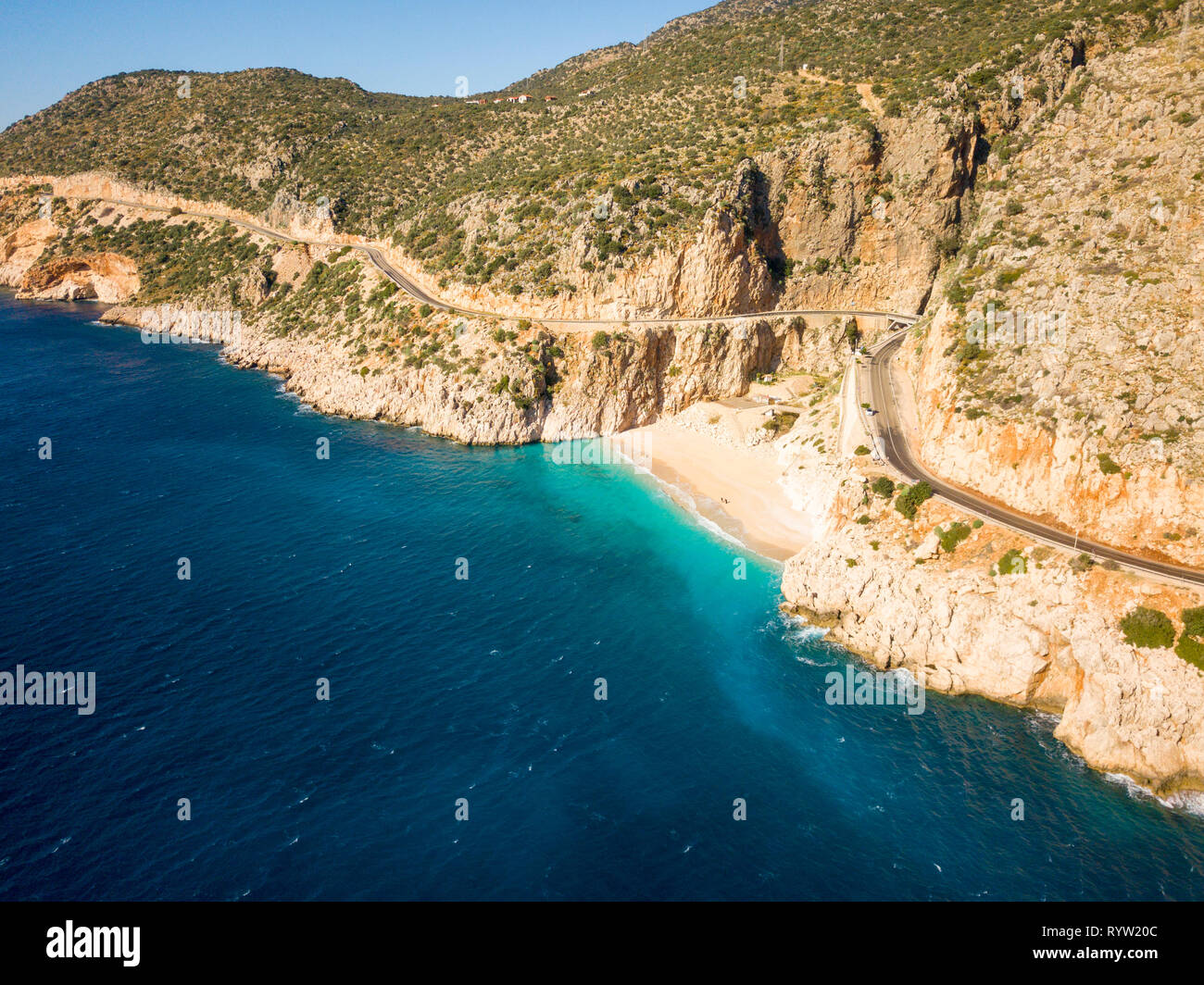 Angled aerial drone view from ocean towards cliffs surrounding Kaputas beach in Turkey Stock Photo