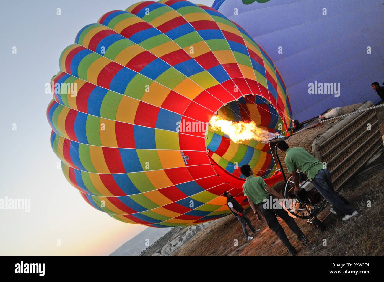 Hot air balloon being inflated by its propane burners prior to launch, Cappadocia, Turkey Stock Photo