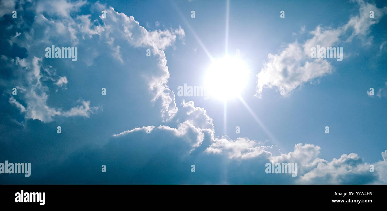 Beautiful scenic view of cloudy, sunny, blue sky in sunny day. This panoramic image is also suitable for banner because of more copy space. Stock Photo