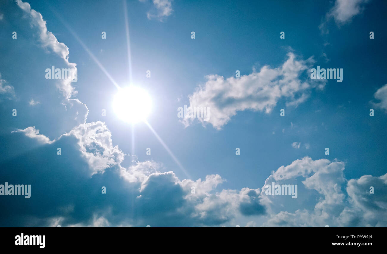 Beautiful scenic view of cloudy, sunny, blue sky in sunny day. Stock Photo
