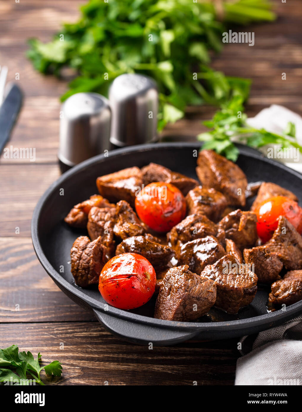 Roasted or stewed beef meat with tomato Stock Photo