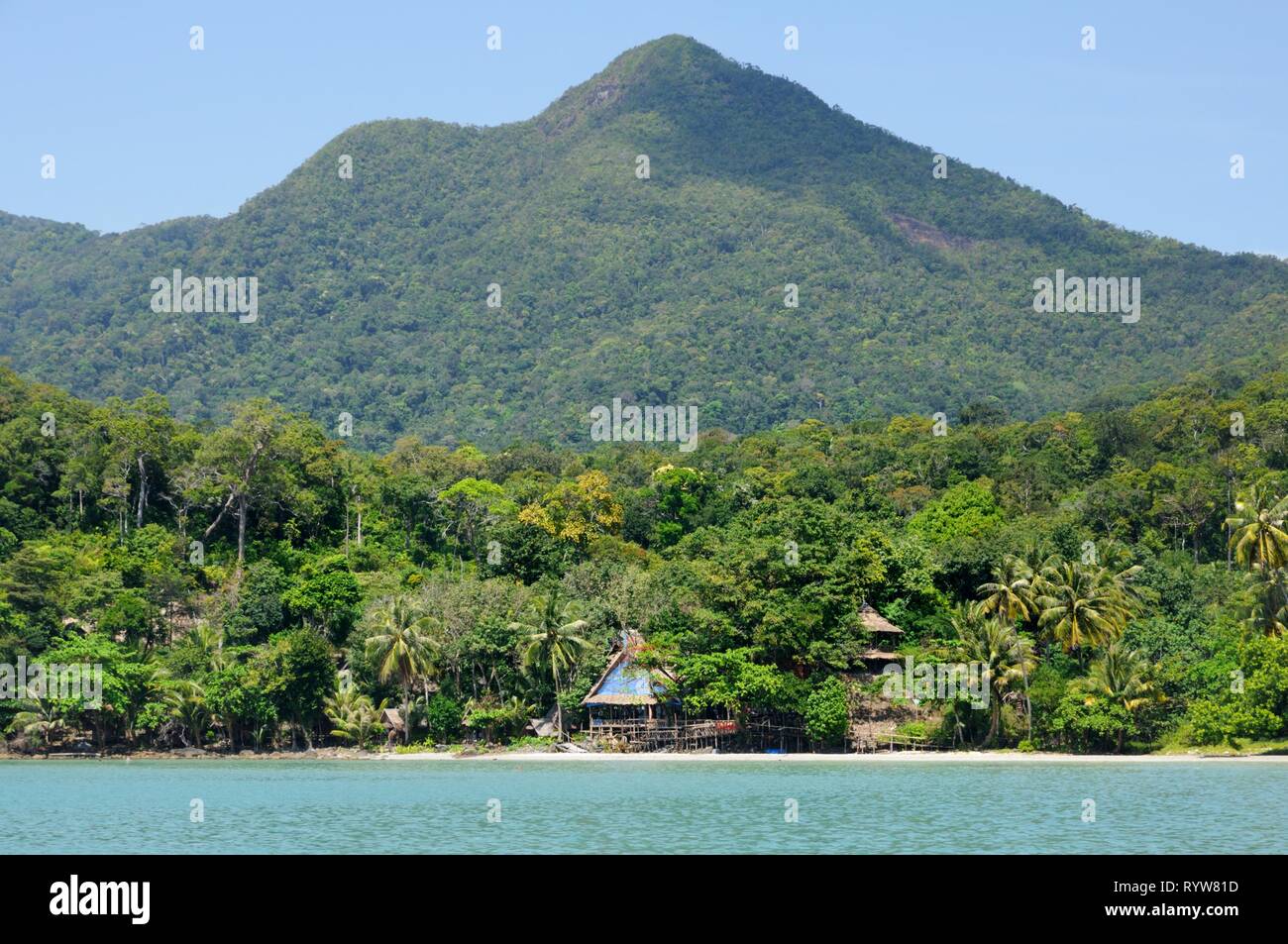 Tropical sea with mountain covered with rainforest and beach resort on horizon on Koh Chang island, Thailand. Stock Photo