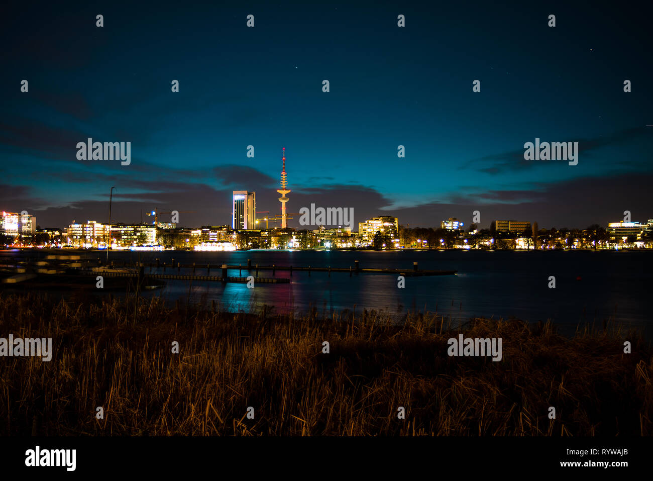 Night view of Hamburg's cityscape across the Alster river Stock Photo