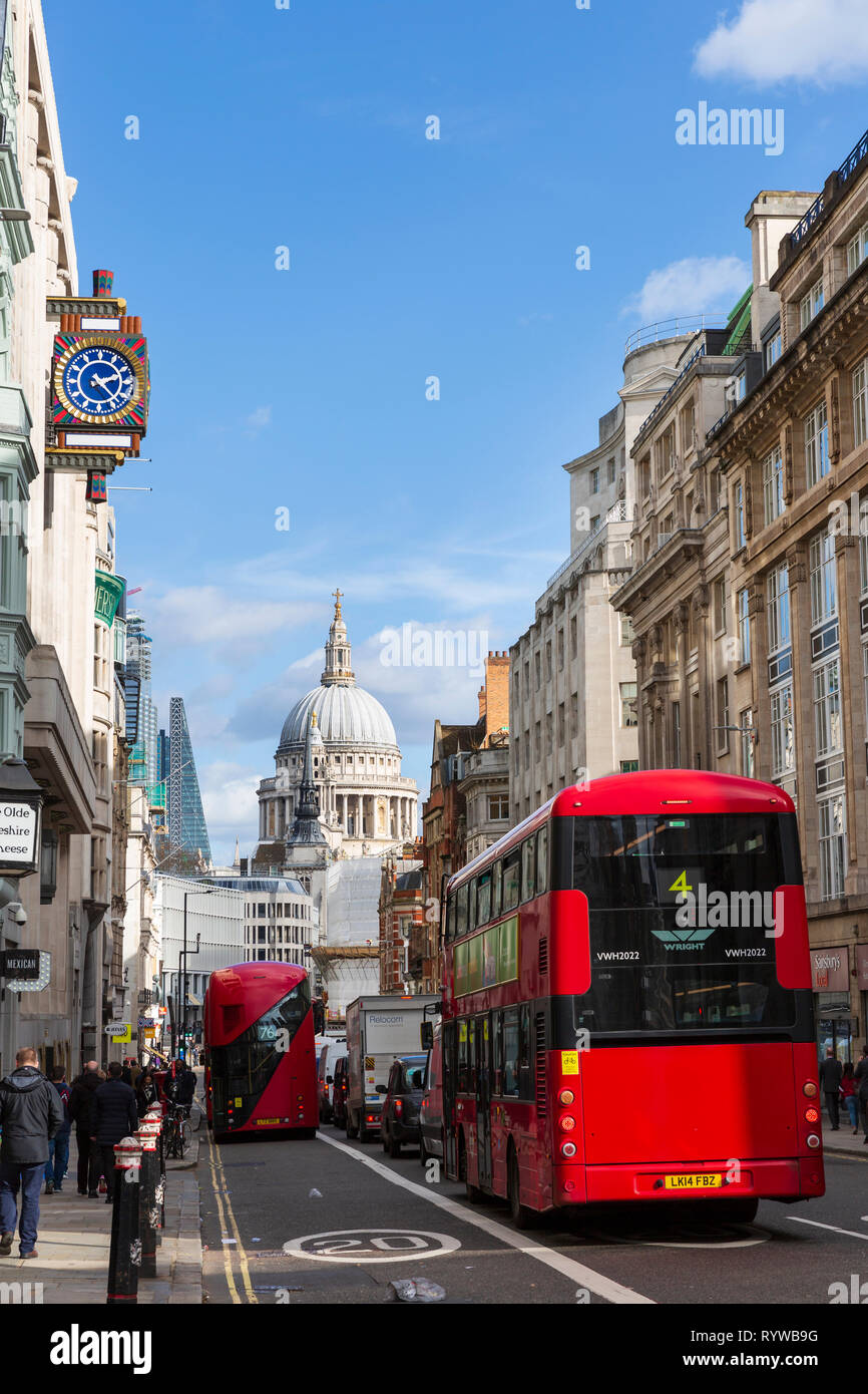 LONDON, UK - MARCH 11, 2019: Red London buses on Fleet Street in London with a view of St Paul's Cathedral in the background. Stock Photo