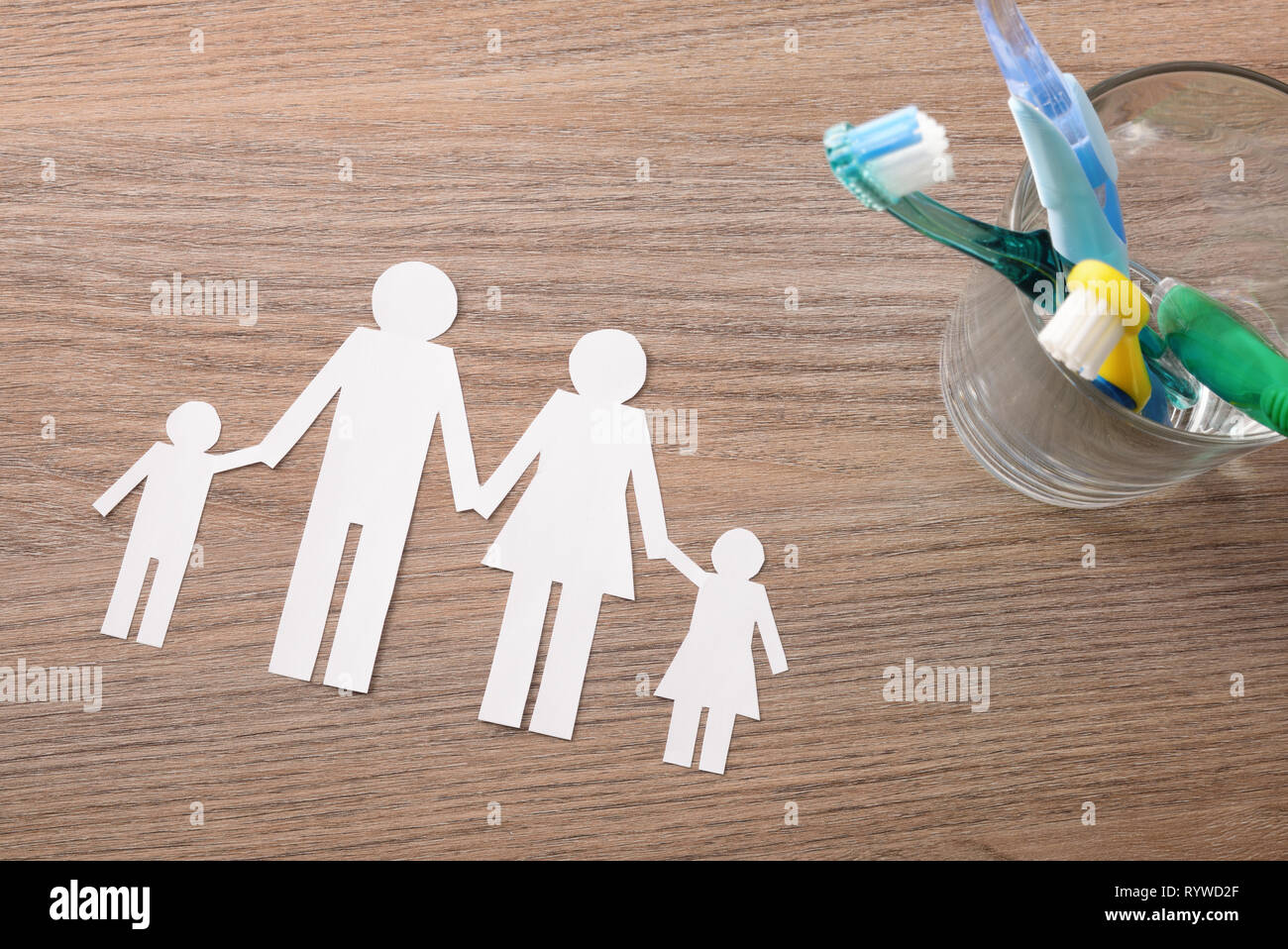 Concept of teeth cleaning at home of the whole family with glass jar ...