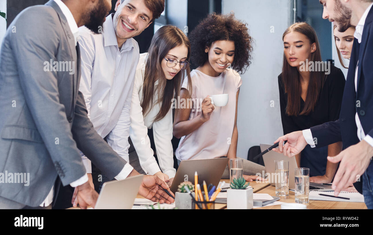Coworkers analyzing data using computers in office Stock Photo