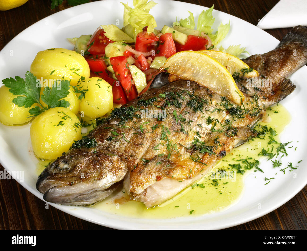 Grilled Trout with Potatos and Salad Stock Photo Alamy