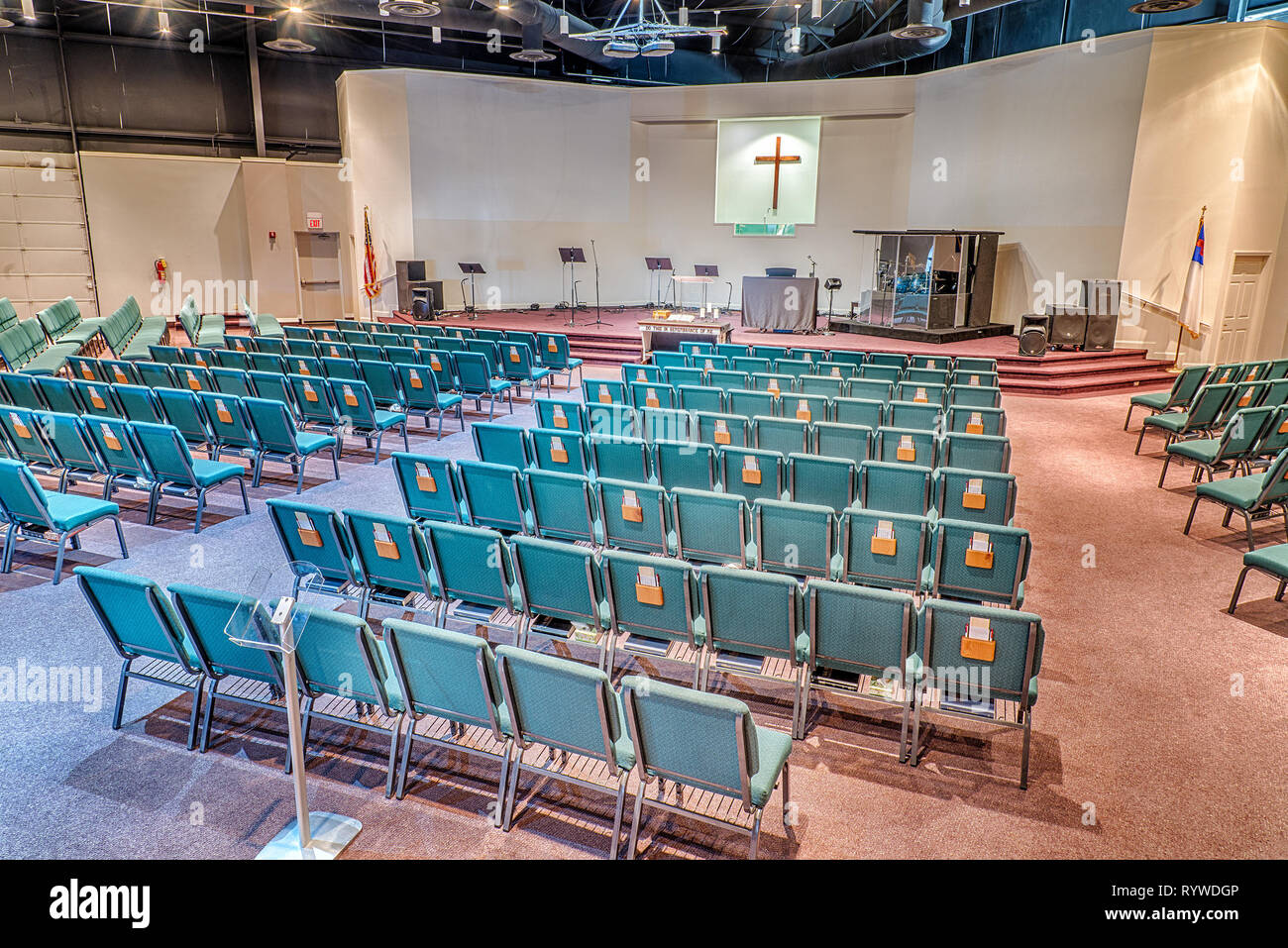 Horizontal shot of a church auditorium from the back facing toward the stage looking from the right side of the sanctuary. Stock Photo