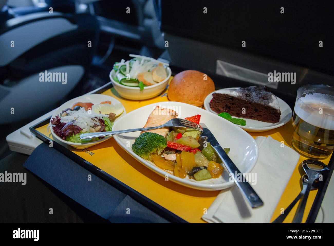 Food served on board of business class airplane on the table. Tray of food in the airplane. Tray of food on the plane, business class travel. Prepared Stock Photo
