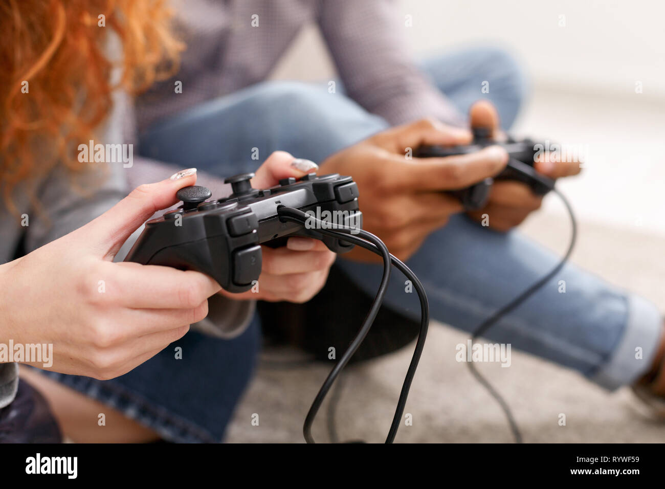 Friends playing video games, having fun at home Stock Photo