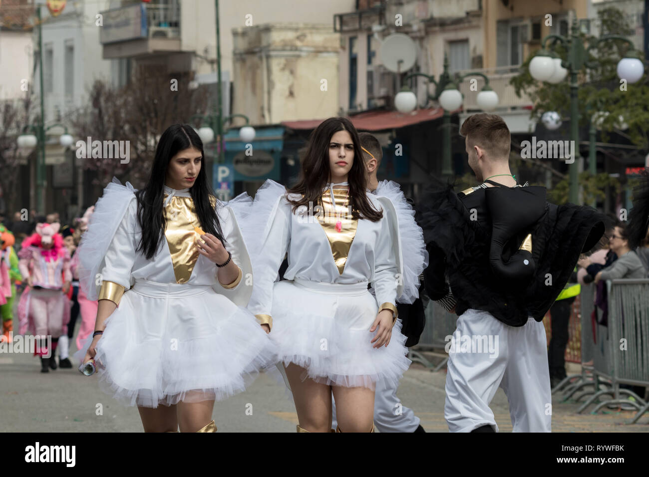 XANTHI, GREECE - MARCH 10, 2019: Masquerade participants march and have fun in colorful costumes. Small and big groups of Greek people parade annually Stock Photo