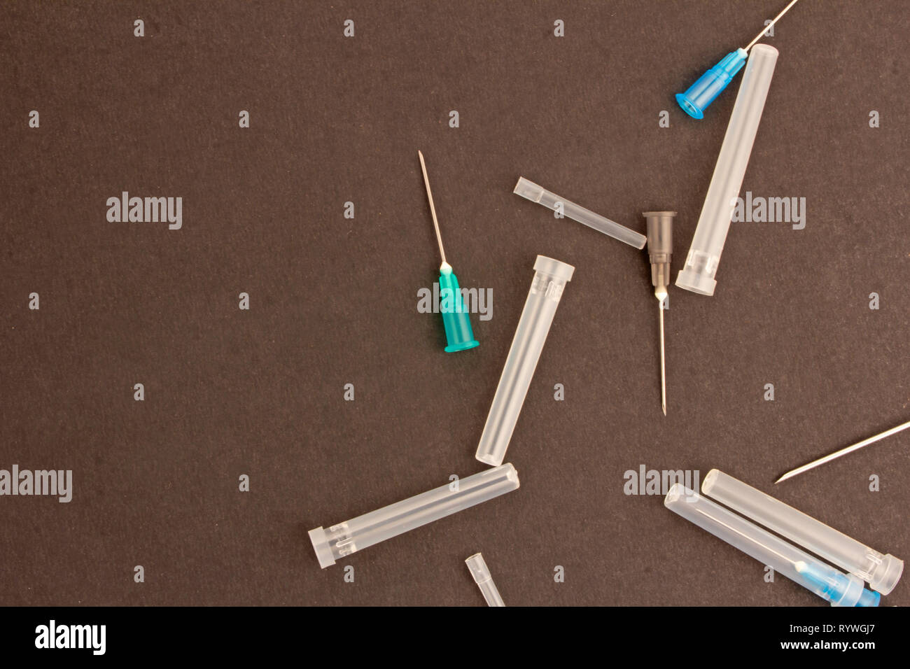 Medical syringes on plain black background Stock Photo