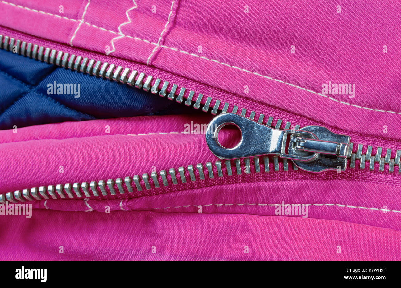 Detail of the zipper of a purple and blue down jacket Stock Photo