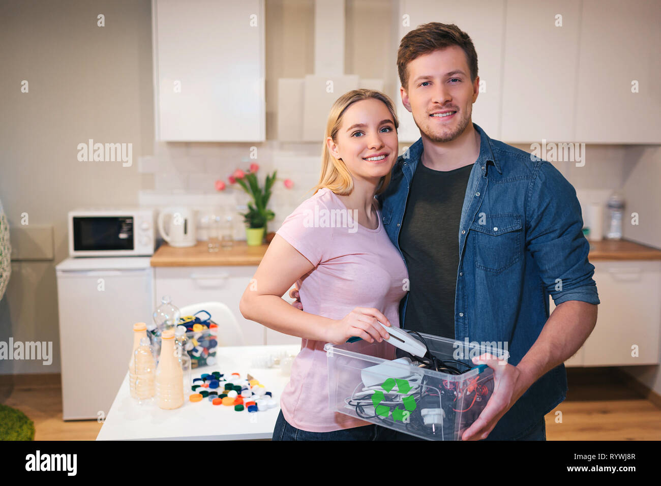Protect the environment. Young smiling couple holding recycling