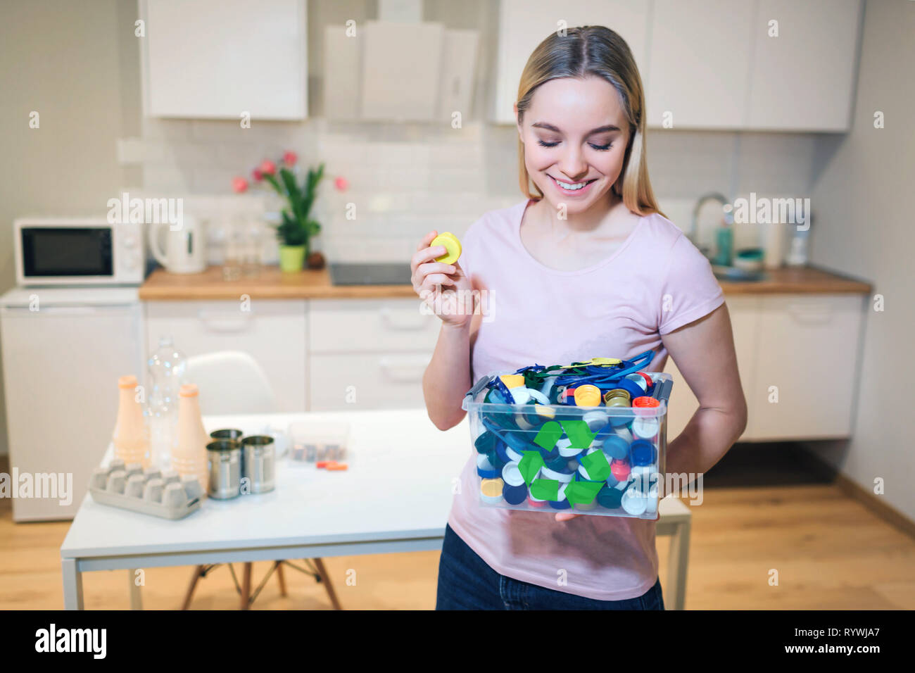 Protect the environment. Plastic lids prepared for recycling. Young