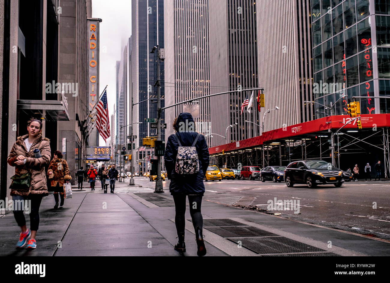 Woman walks alone through New York City on a cold winters day Stock