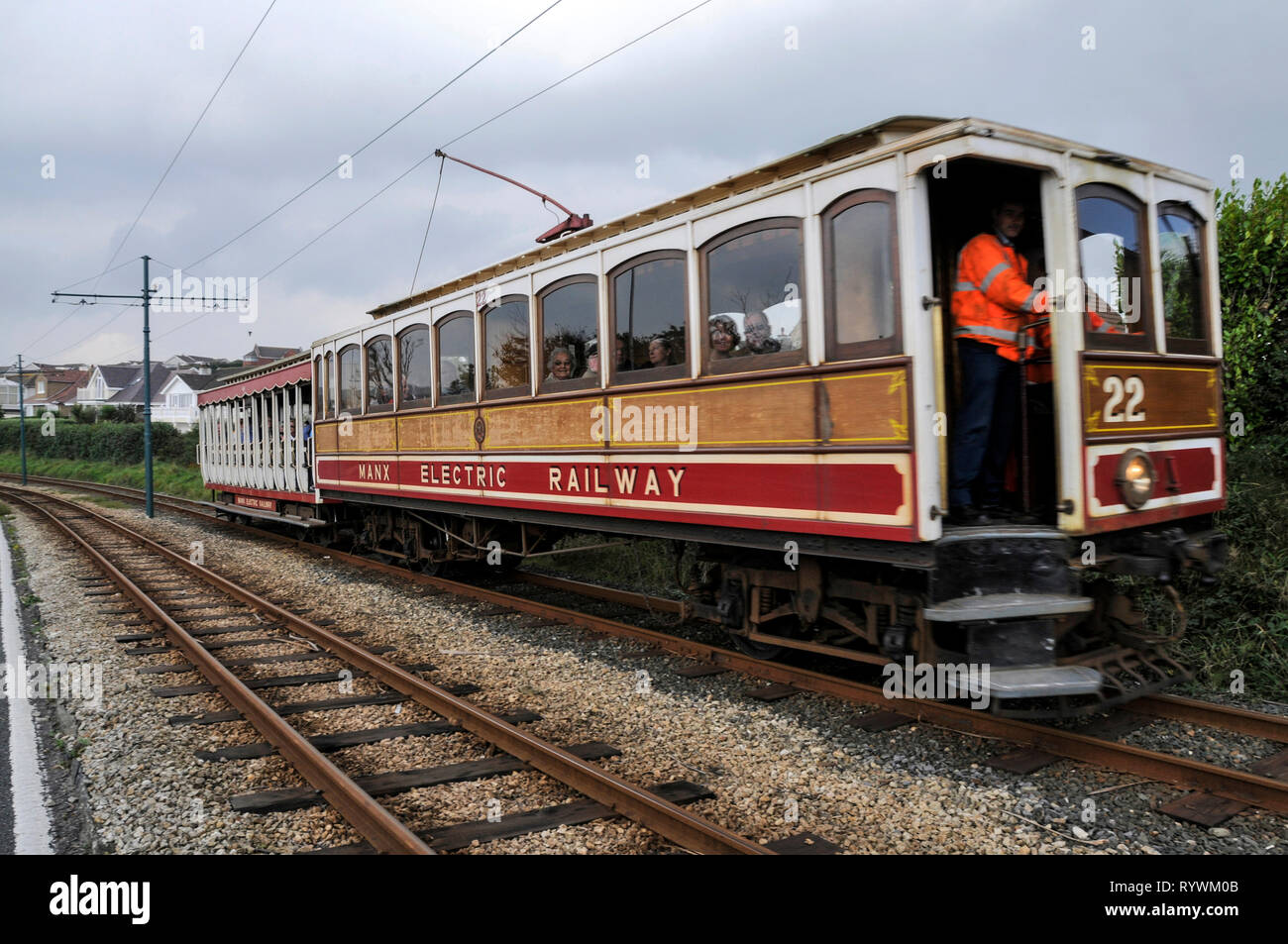An electric tram on the 17 miles long, rail track connecting Ramsey and Douglas on the Isle of Man, Britain.  The Isle of Man with its capital city, D Stock Photo