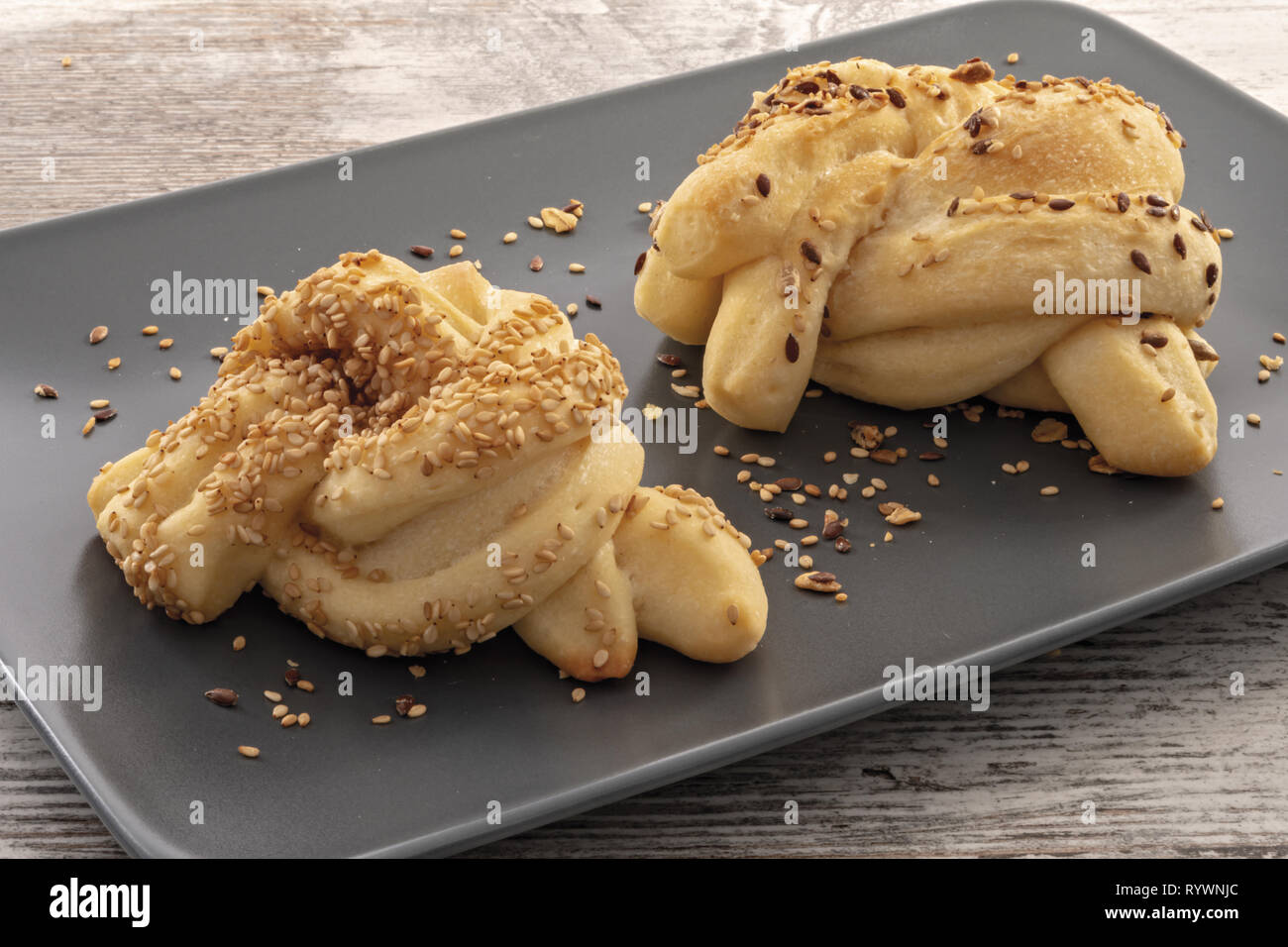 pane italiano con seme vari su vassoio scuro da vicino Stock Photo