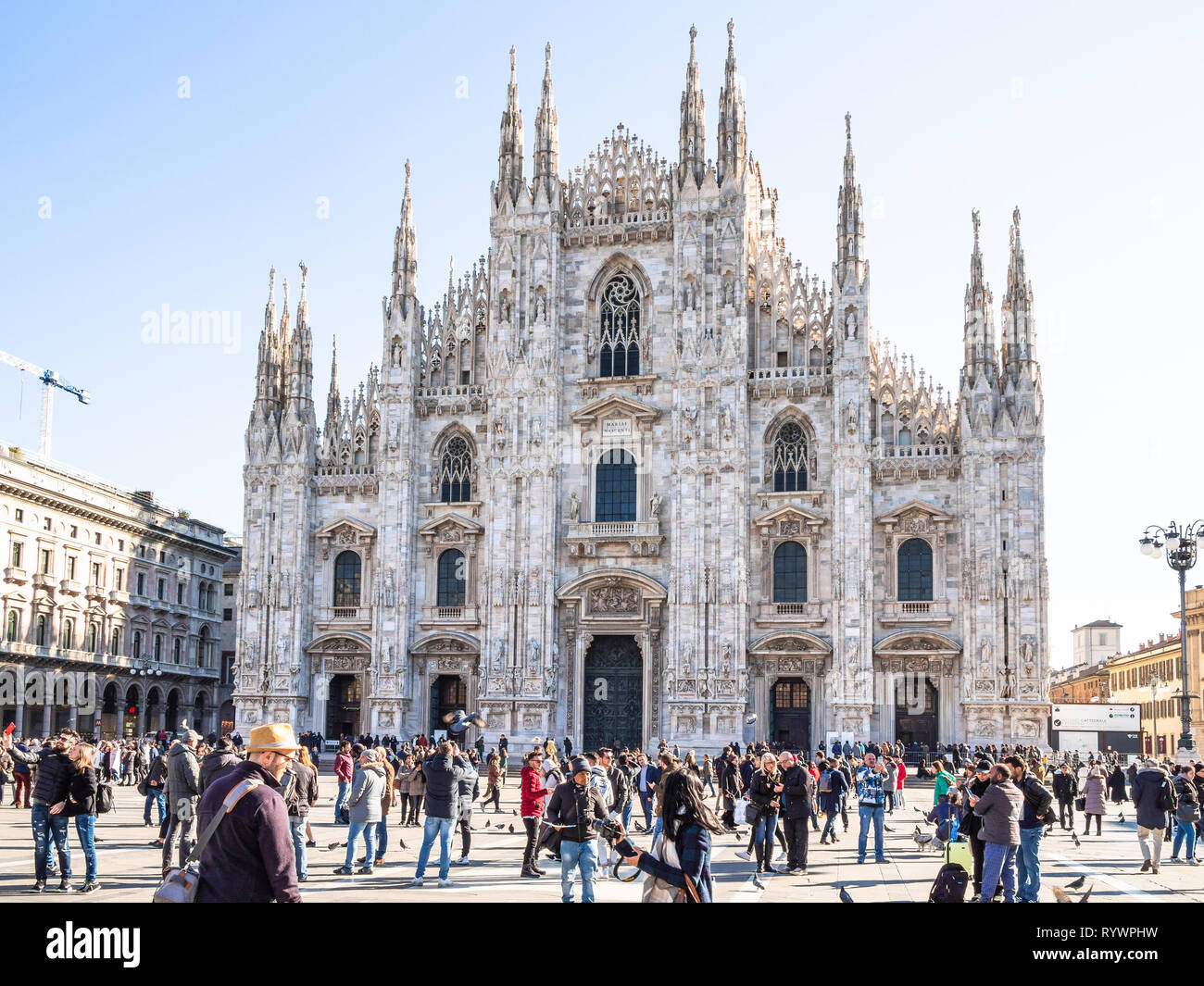 MILAN, ITALY - FEBRUARY 24, 2019: tourists on square Piazza del Duomo in front of Milan Cathedral (Duomo di Milano) in Milan city in morning. This Bas Stock Photo