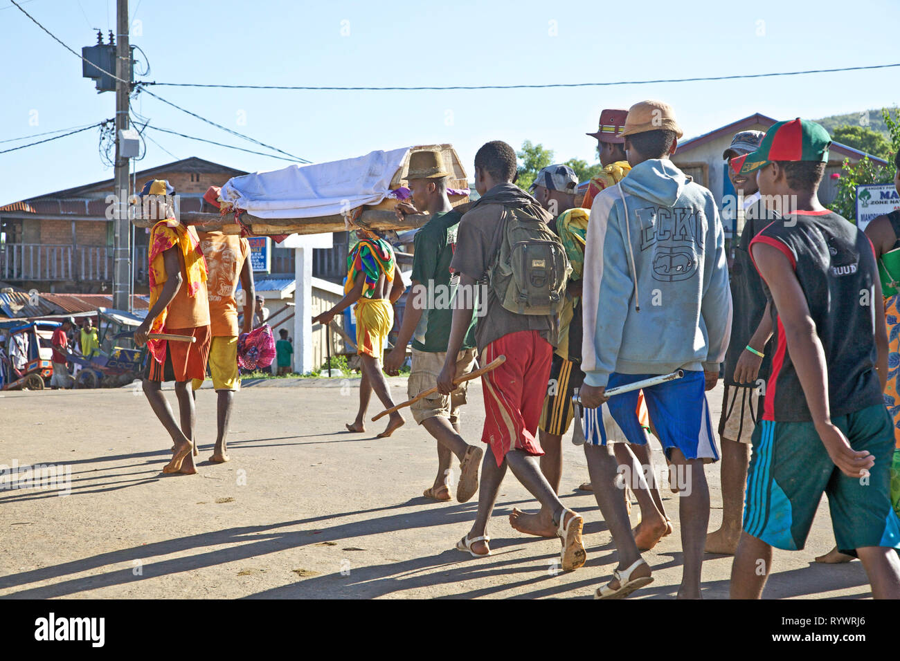 Young men carry coffin in Miandrivazo, Madagascar. Stock Photo