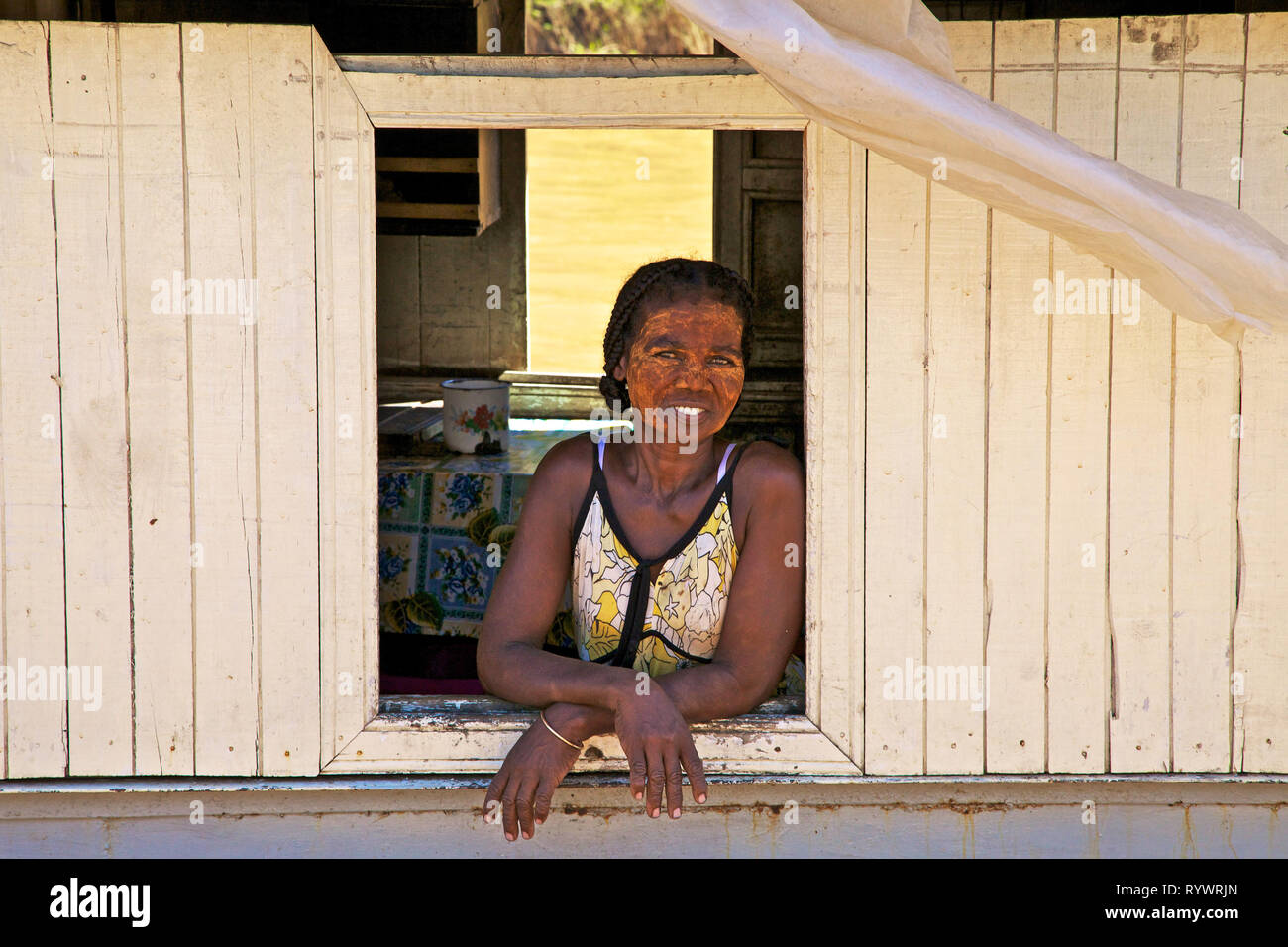 Portrait of woman with sun protection on her face on the boat, Tsiribihina river, Madagascar. Stock Photo
