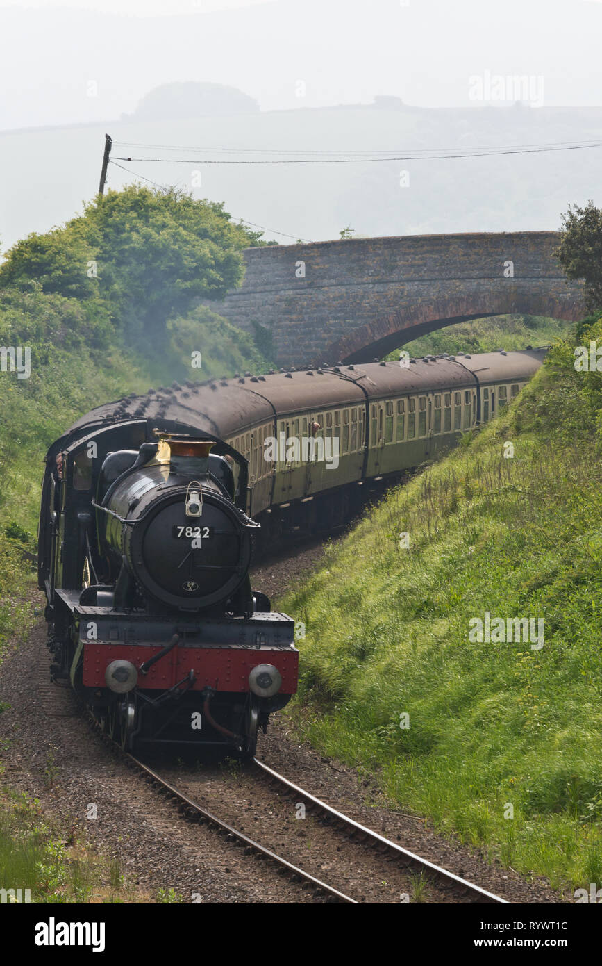 Locomotive 7822, Foxcote Manor, on her way to Watchet station having just passed under Howells Bridge on the West Somerset Railway. Stock Photo
