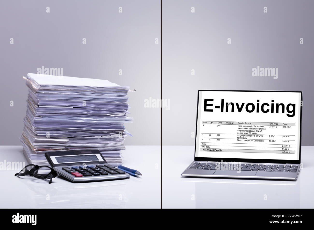 Stacked Of E-invoice Paper And Calculator Is Replace With New Technology Against White Background Stock Photo