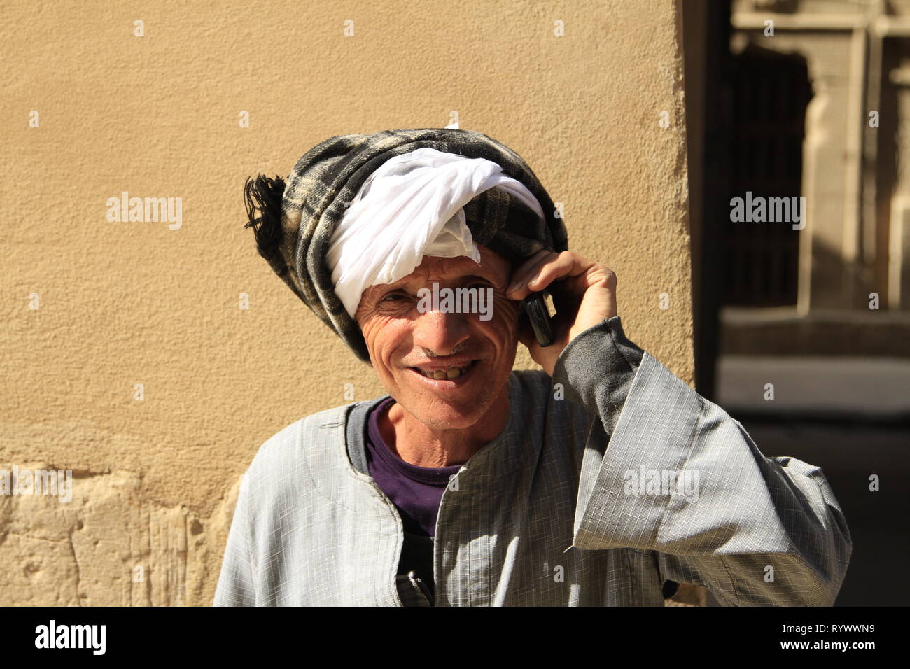 Egyptian temple guard talking on his cell phone near the Temple of