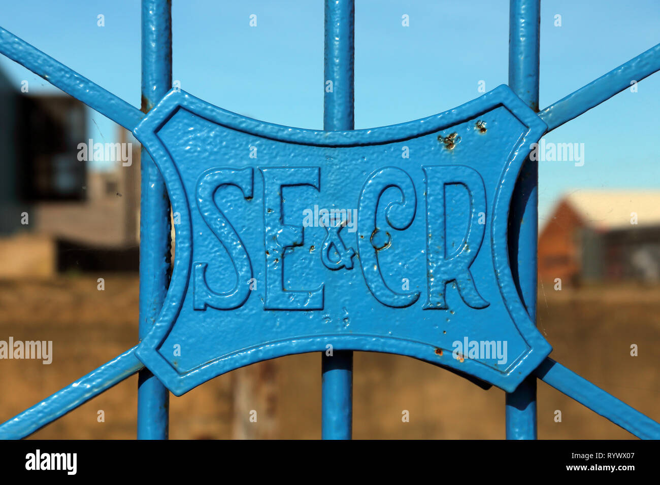 A Victorian cast iron plate reading 'South Eastern and Chatham Railway' attached to gates leading to Whitstable harbour, Kent, England. Stock Photo