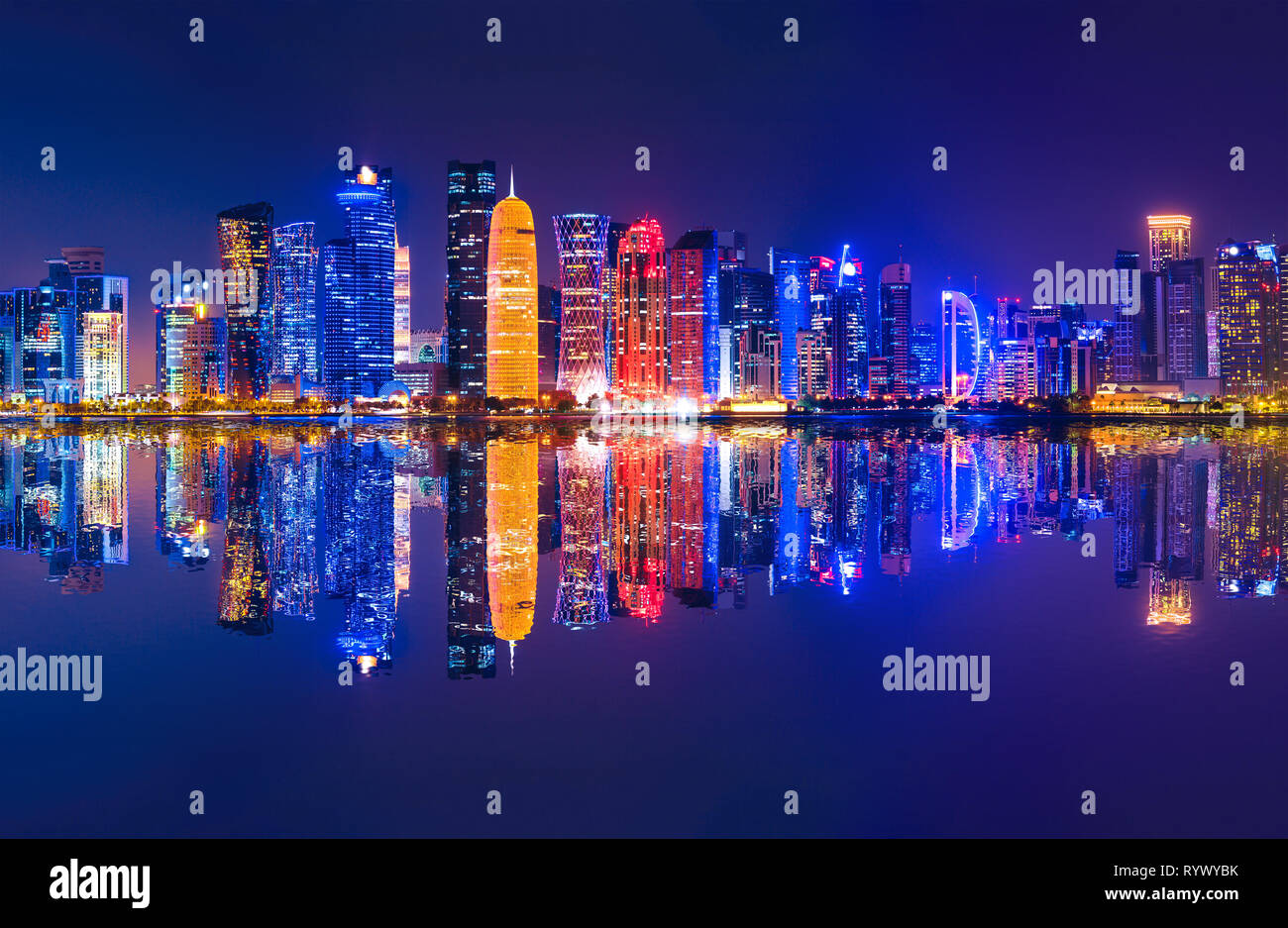 The Capital city of Qatar by night. Doha West Bay skyline reflecting in Doha Bay. Modern glassed skyscrapers of Doha in Qatar, Middle East, Arabian Stock Photo