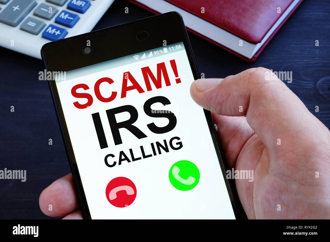 Hand is holding phone with irs scam calls. Stock Photo