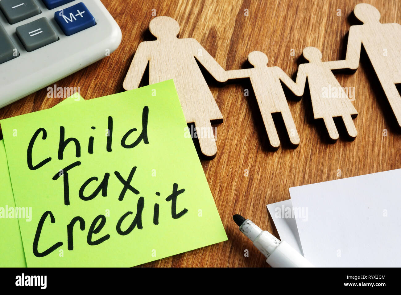 Child Tax Credit Ctc Concept Wooden Figures Of Family And Calculator Stock Photo Alamy