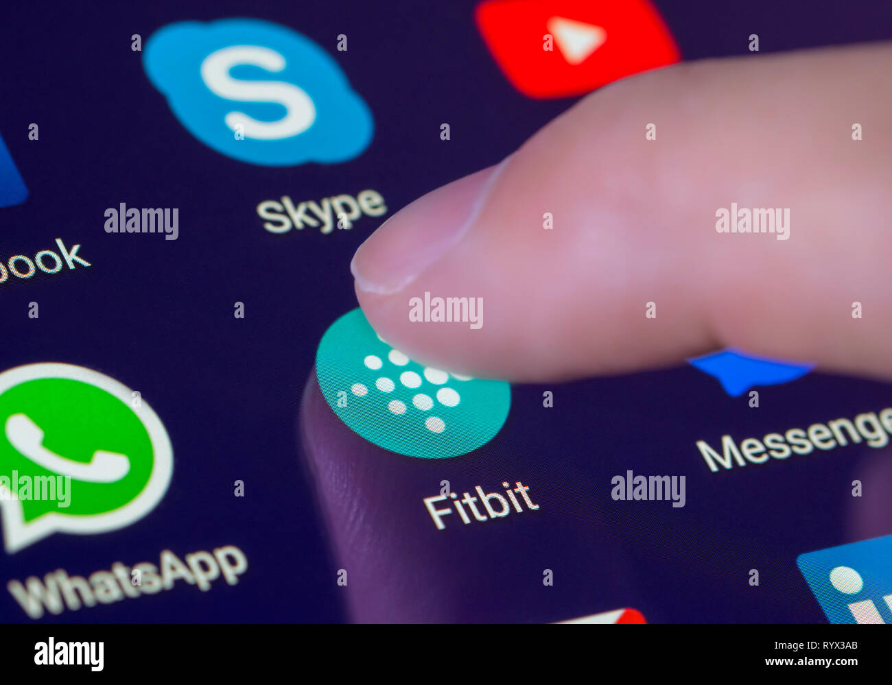 Finger pressing the Fitbit app icon on a tablet or mobile phone  touchscreen. Fitbit shortcut Stock Photo - Alamy