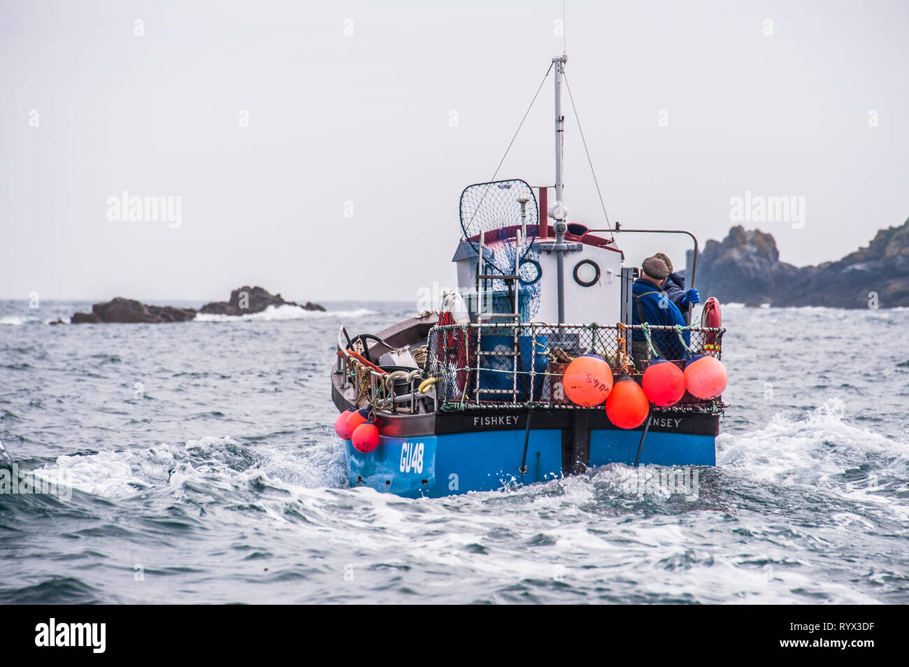 Fishing boat Fishkey leaving Sark for a day's work photographed from another boat Stock Photo