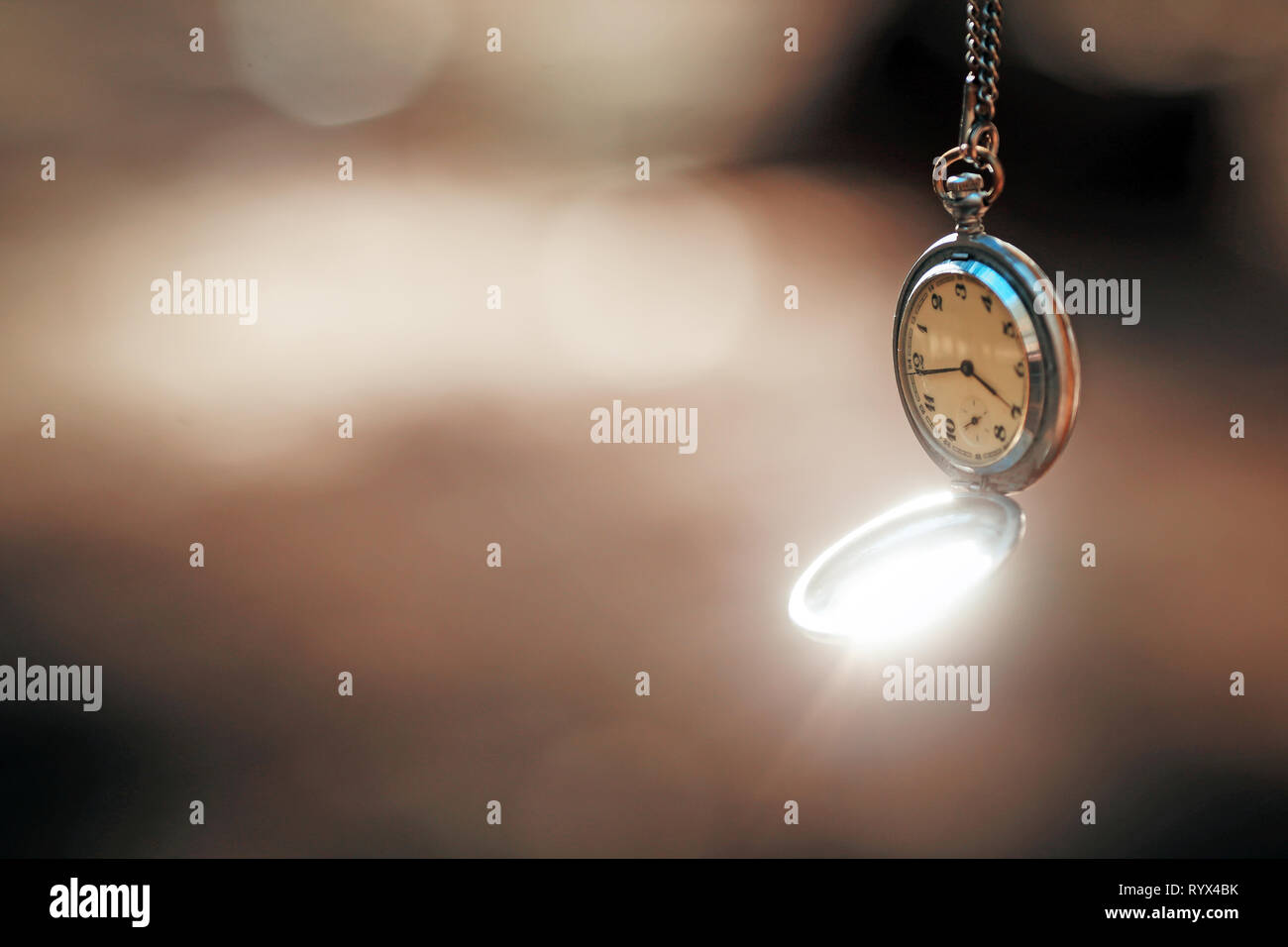 retro clock on a rope on a beautiful background Stock Photo Alamy