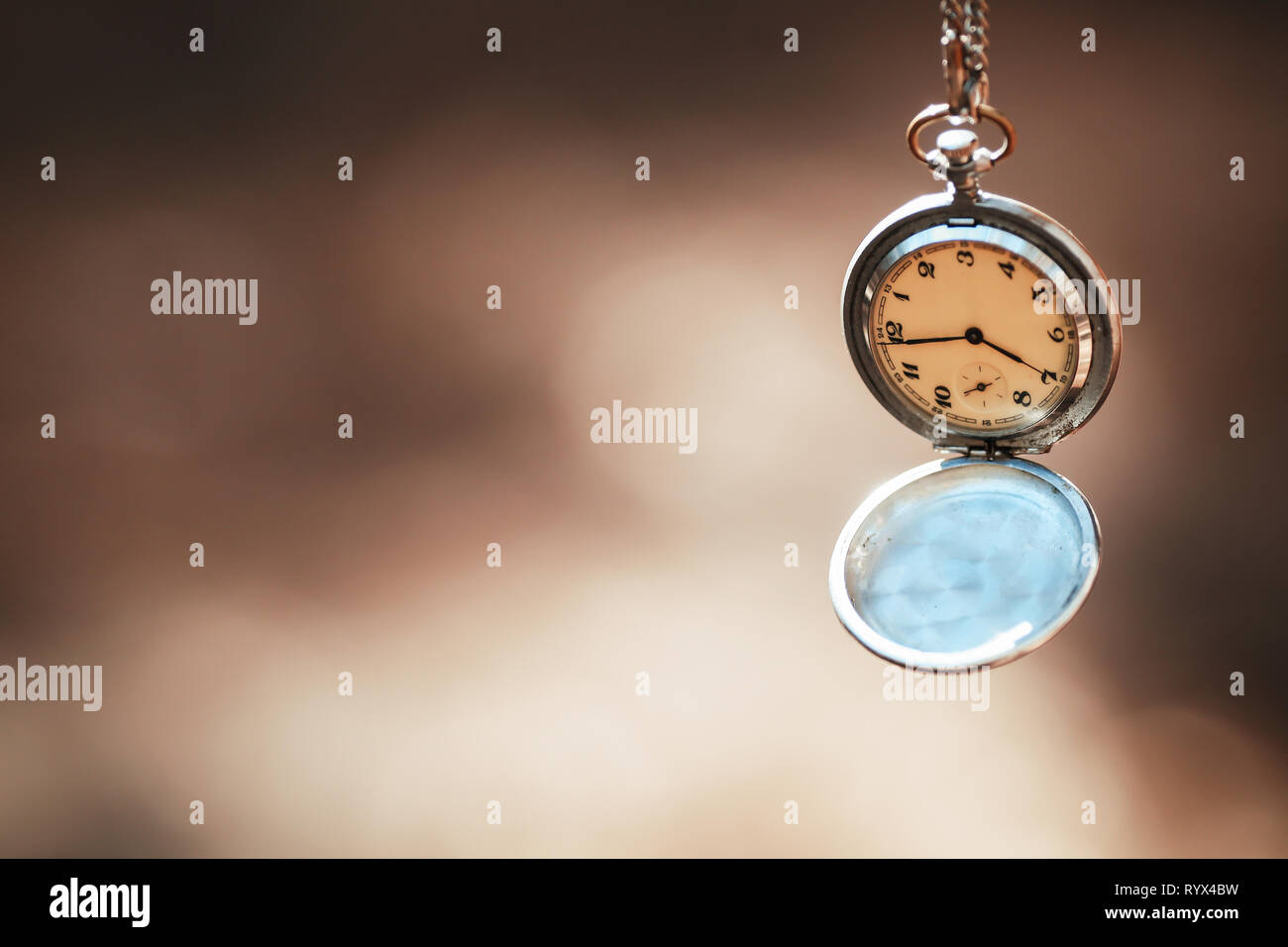 retro clock on a rope on a beautiful background Stock Photo Alamy