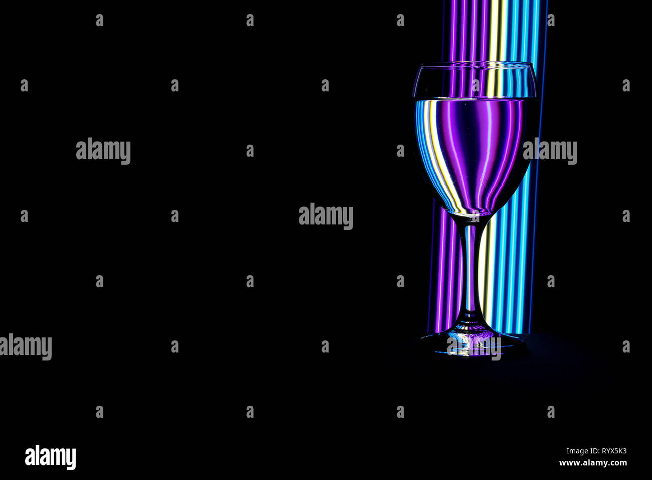 Wine glass / glasses isolated on a black background with colorful