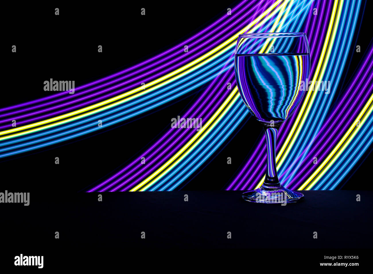 Wine glass / glasses isolated on a black background with colorful