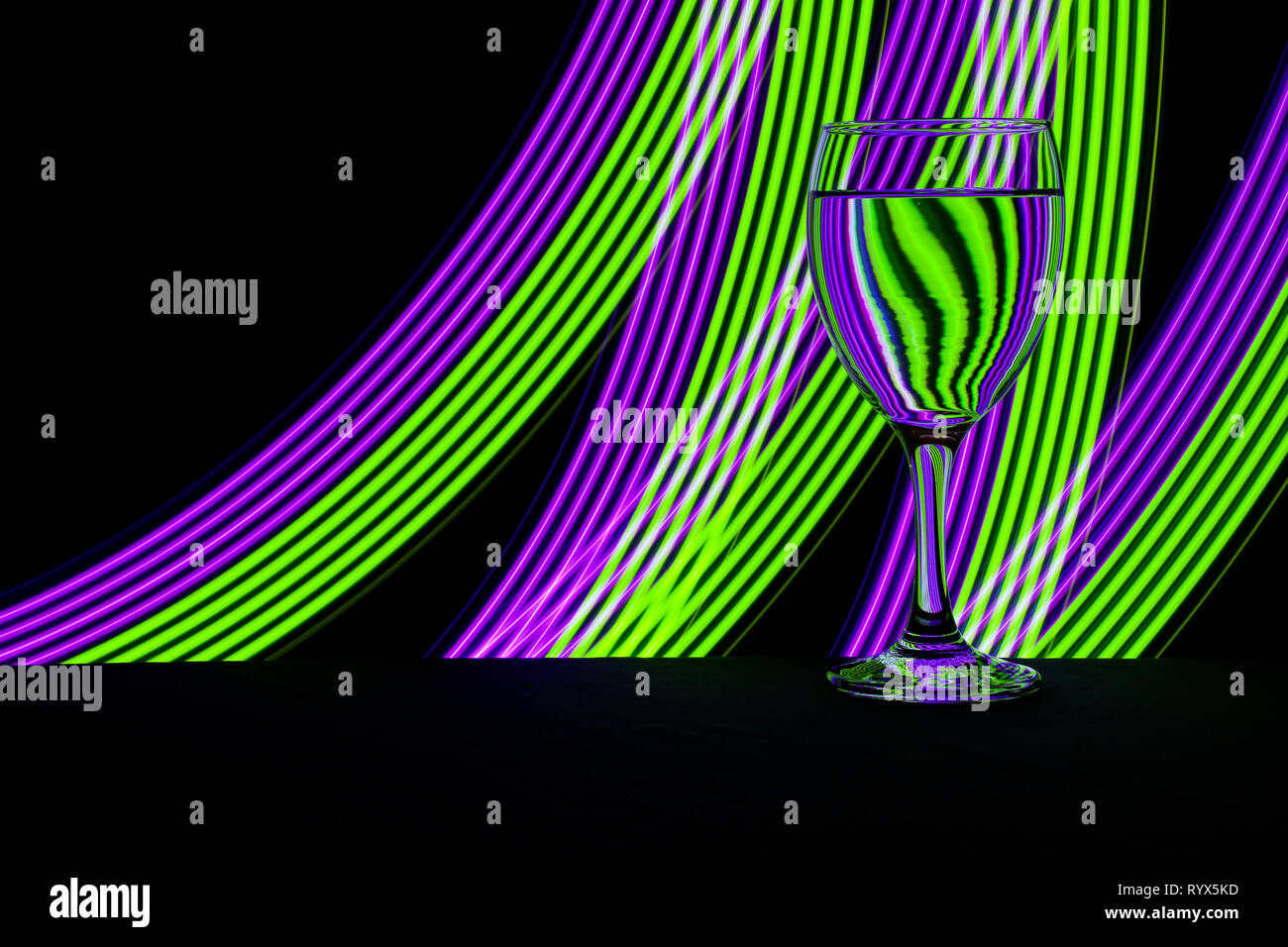 Wine glass / glasses isolated on a black background with colorful