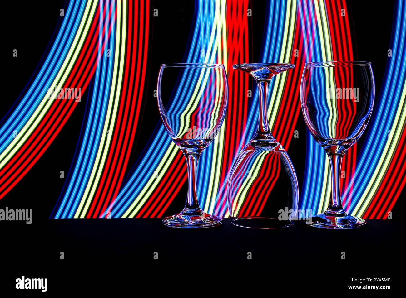 Wine glass / glasses isolated on a black background with colorful