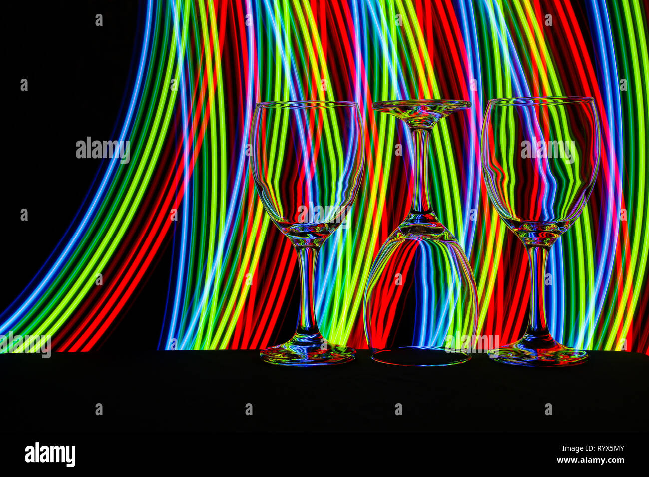 Wine glass / glasses isolated on a black background with colorful