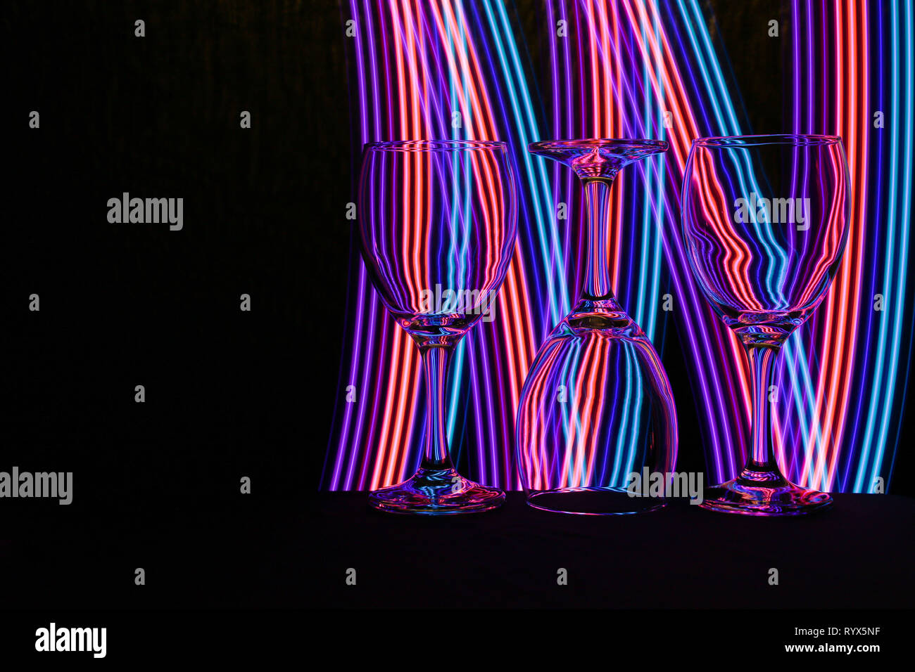 Wine glass / glasses isolated on a black background with colorful