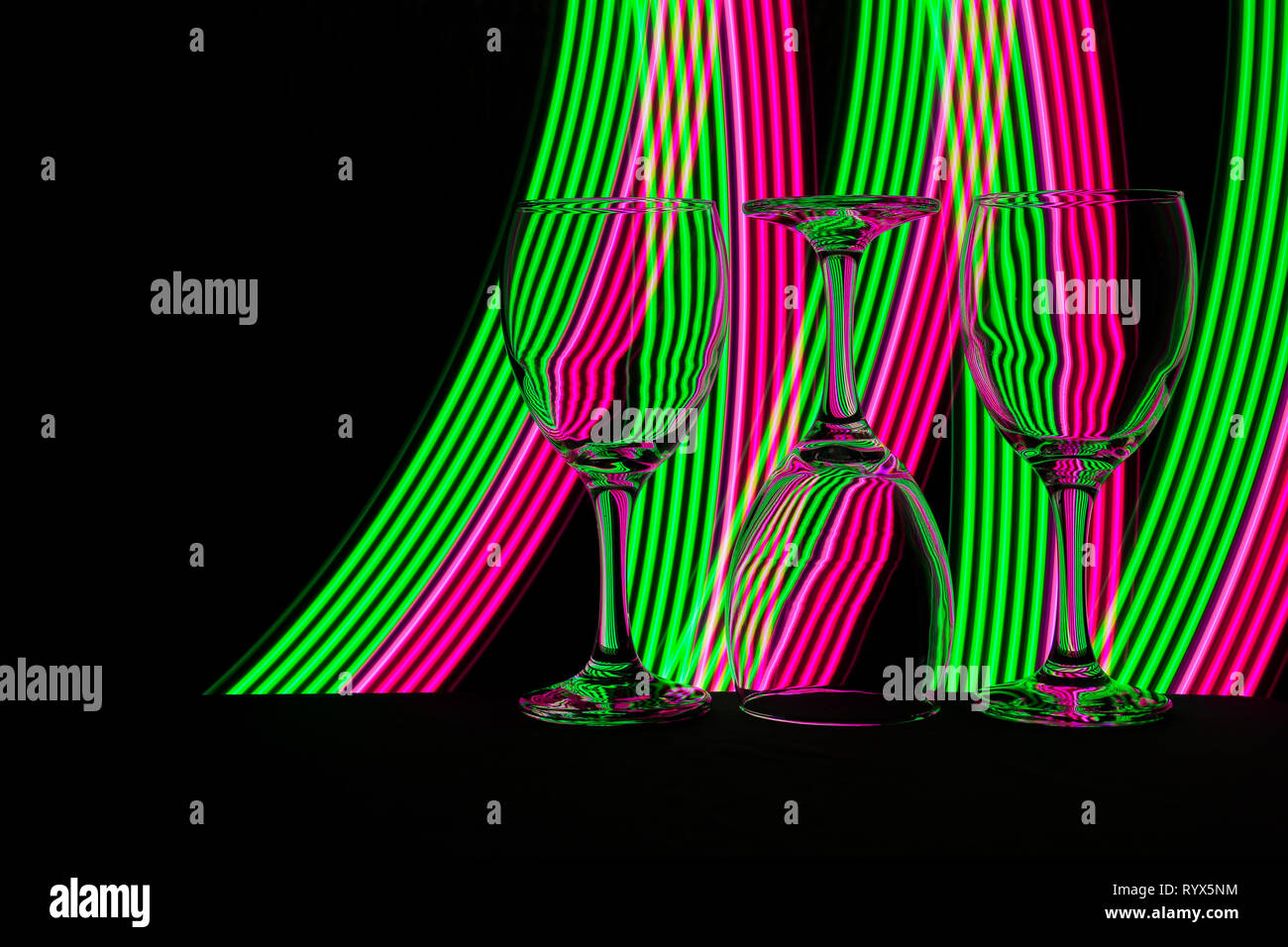 Wine glass / glasses isolated on a black background with colorful